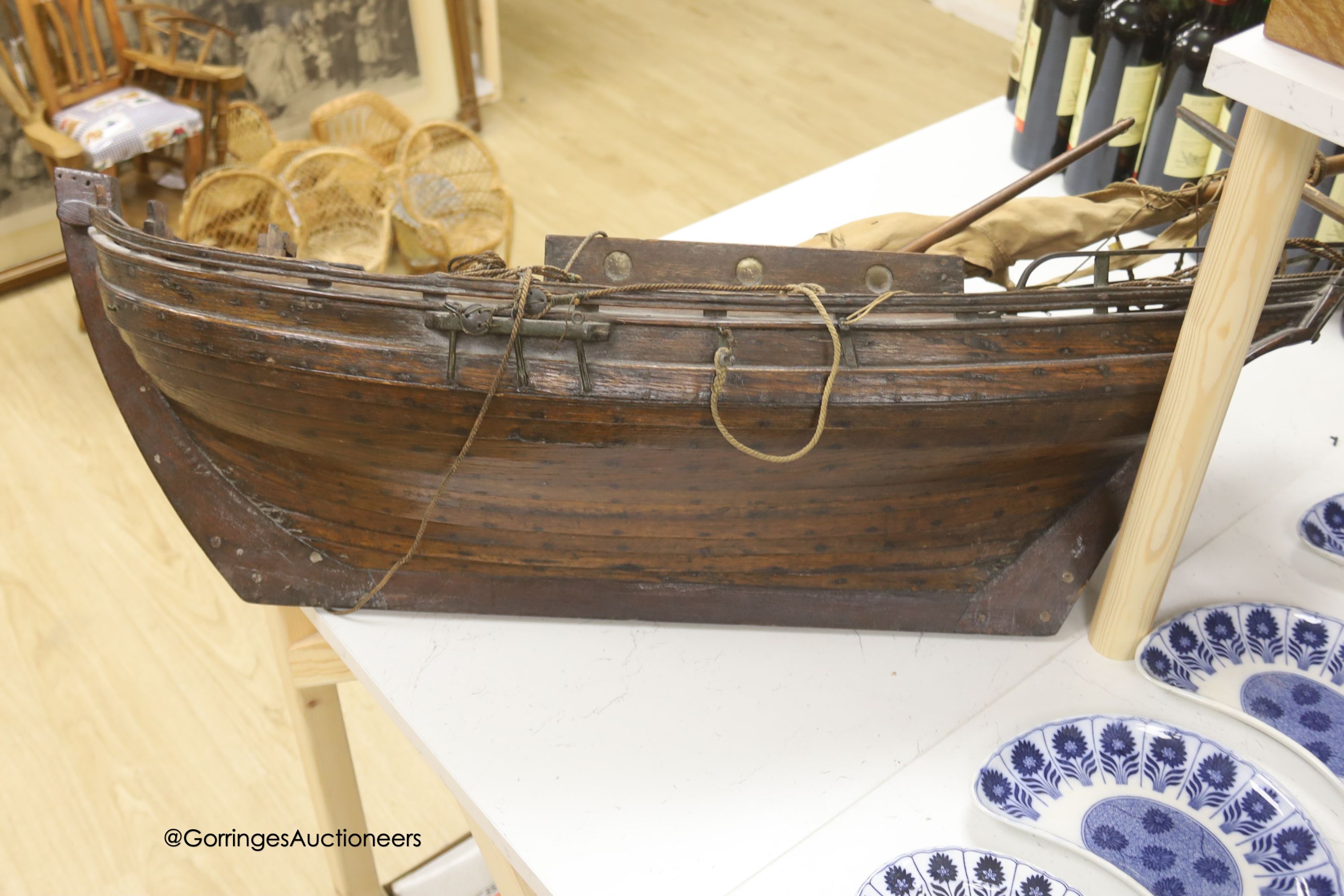 A 19th century clinker-built wood model sailing boat, single masted with main sail and boom, 96cm